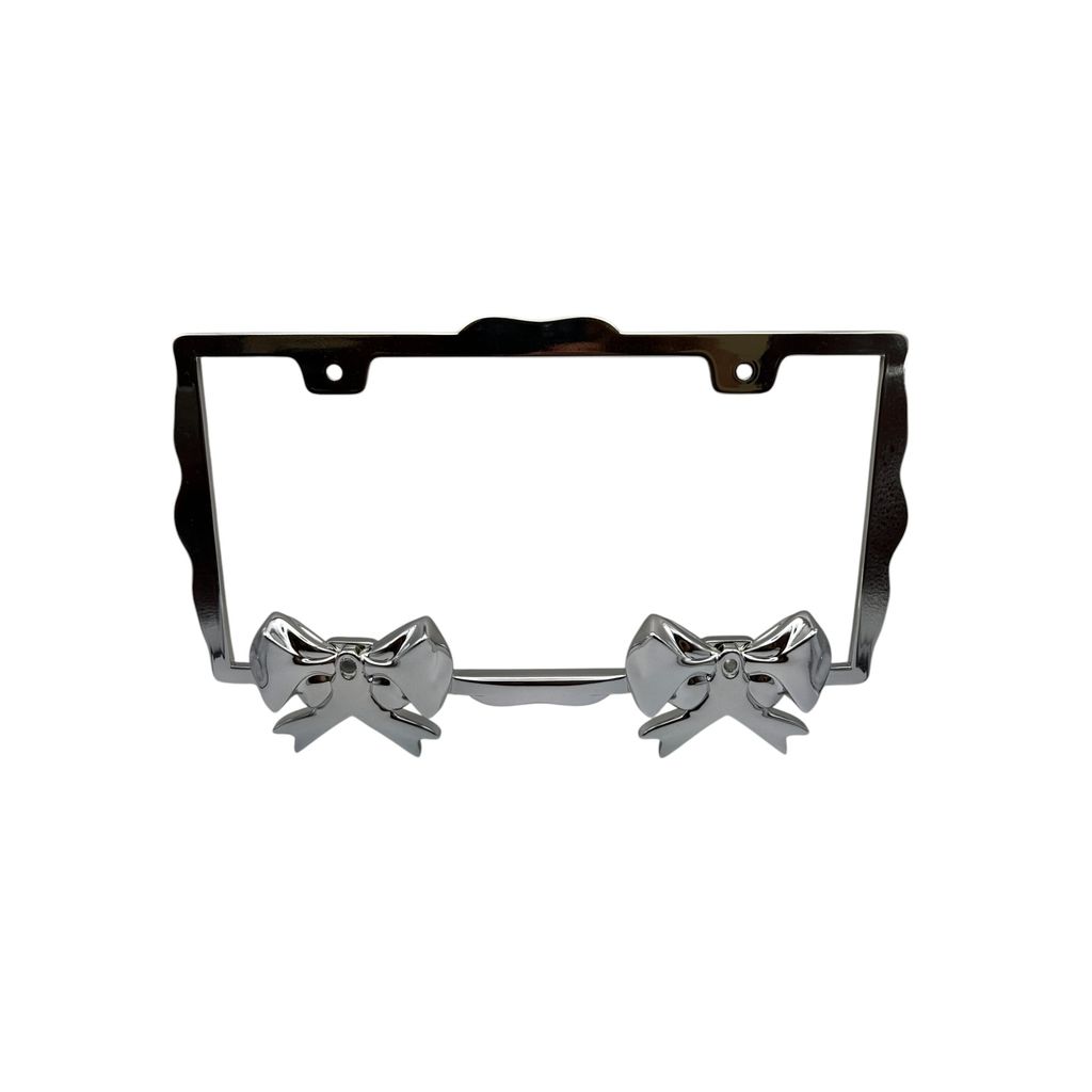 Close-up of polished chrome sculpted bow accents on WANTON license plate frame for U.S. cars