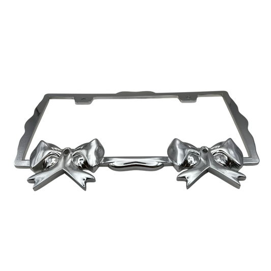 Front view of chrome sculpted bow license plate frame, durable weather-resistant finish