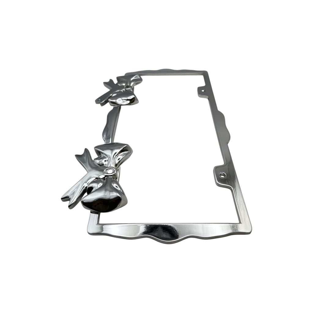 Polished chrome license plate frame with sculpted bow accents on white background