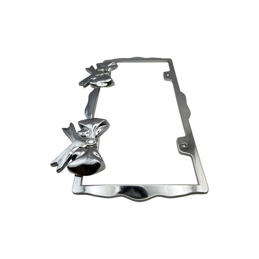 Polished chrome license plate frame with sculpted bow accents on white background