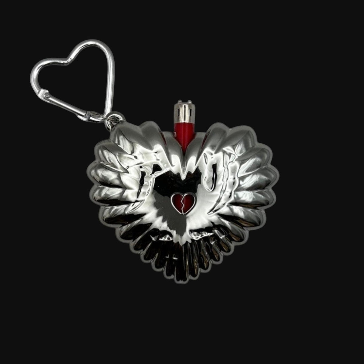 Chrome heart-shaped bic mini lighter case with a red lighter inside on a black background